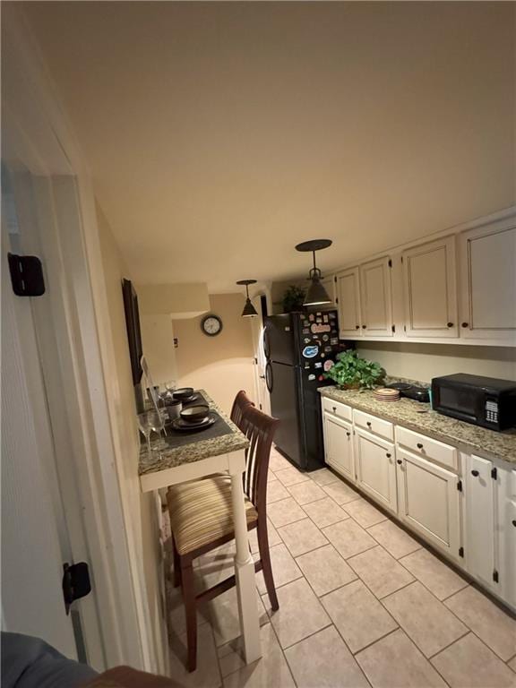 334 Eagle Cir, Dillard, GA 30537 - kitchen featuring black appliances, light tile patterned floors, white cabinets, and light stone countertops