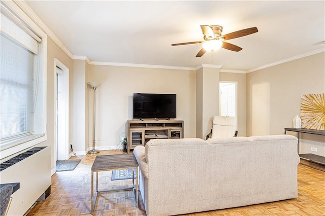living room with radiator heating unit, a ceiling fan, ornamental molding, and baseboards