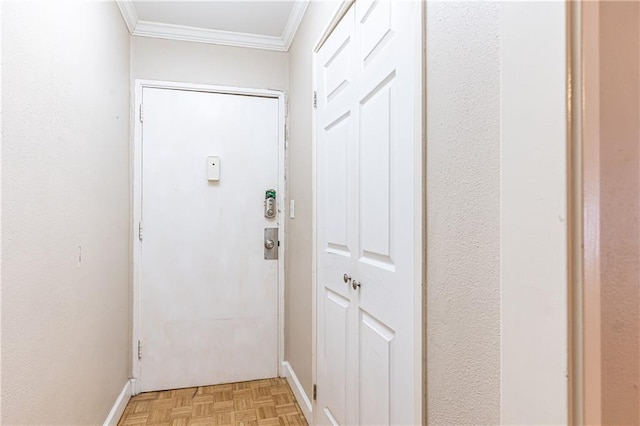 entryway with ornamental molding and baseboards