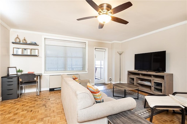 living room with baseboards, ornamental molding, and a ceiling fan