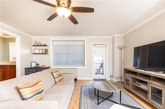 living room featuring baseboards, ceiling fan, and ornamental molding