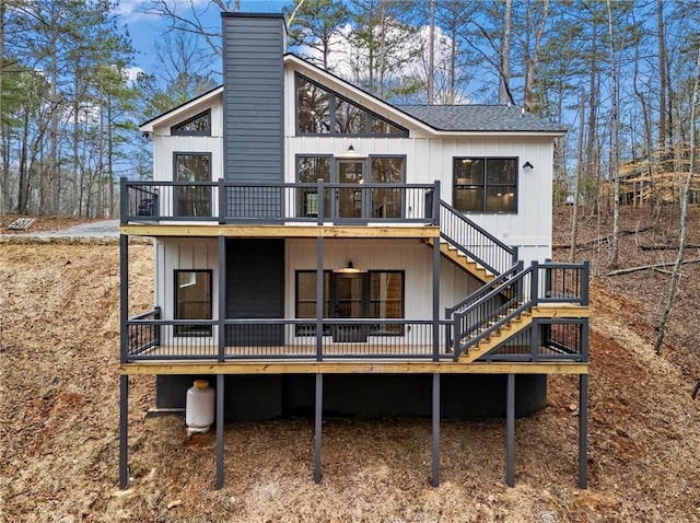 rear view of property featuring a wooden deck