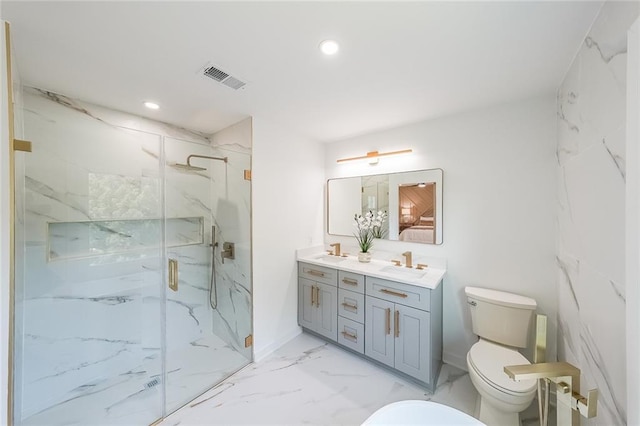 bathroom with vanity, toilet, and a shower with shower door