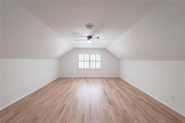 additional living space featuring ceiling fan, light wood-type flooring, and lofted ceiling