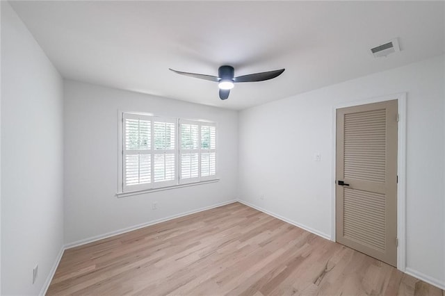 spare room with light wood-type flooring and ceiling fan