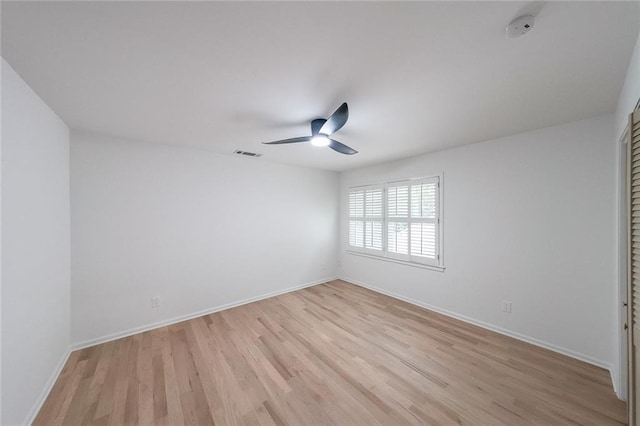 spare room featuring ceiling fan and light hardwood / wood-style flooring