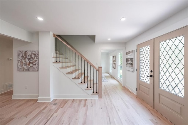 foyer featuring french doors and light hardwood / wood-style floors