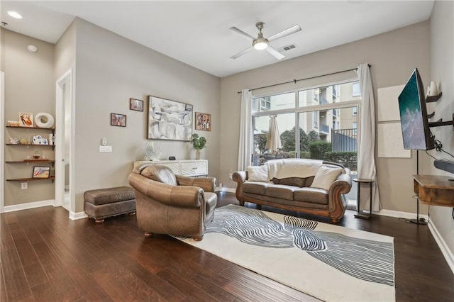 living room with ceiling fan and dark hardwood / wood-style flooring