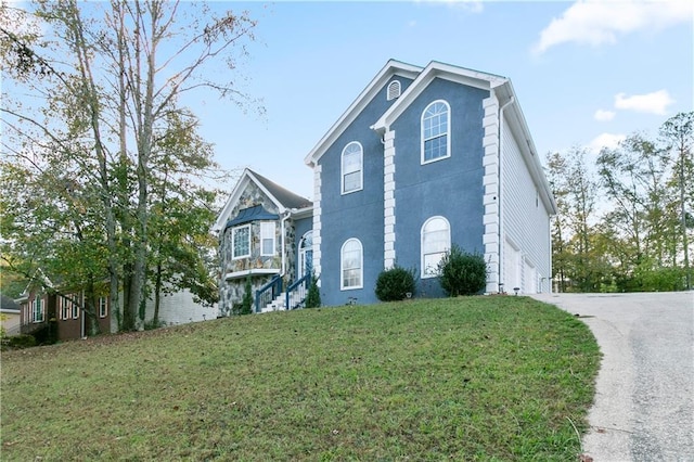 view of home's exterior featuring a garage and a lawn