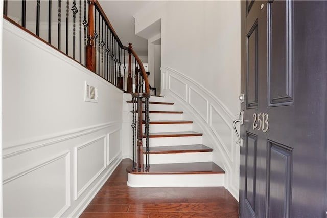 2513 Friar Tuck Ln SE Unit 1, Atlanta, GA 30339 - stairs with a decorative wall, wood finished floors, and wainscoting