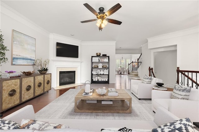 2513 Friar Tuck Ln SE Unit 1, Atlanta, GA 30339 - living room featuring ornamental molding, stairs, a ceiling fan, a glass covered fireplace, and wood finished floors