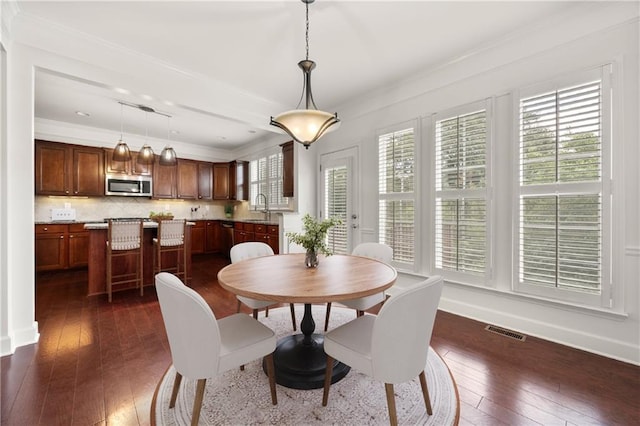 2513 Friar Tuck Ln SE Unit 1, Atlanta, GA 30339 - dining space featuring plenty of natural light, dark wood finished floors, ornamental molding, and baseboards