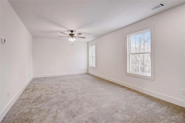 carpeted empty room featuring ceiling fan