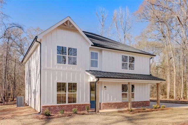 view of front of home featuring cooling unit and a porch