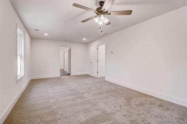 unfurnished room featuring ceiling fan and carpet flooring