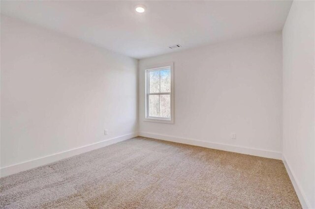 empty room featuring light carpet