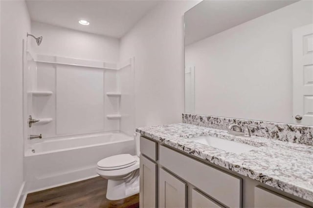 full bathroom featuring wood-type flooring, vanity, toilet, and shower / bathing tub combination