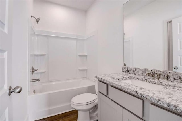 full bathroom featuring hardwood / wood-style floors,  shower combination, vanity, and toilet