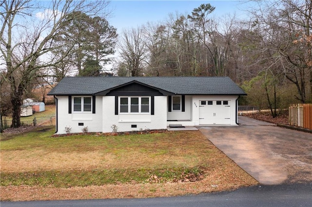 view of front of property with a garage and a front lawn