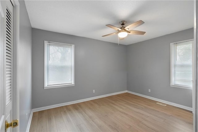 spare room featuring ceiling fan and light wood-type flooring