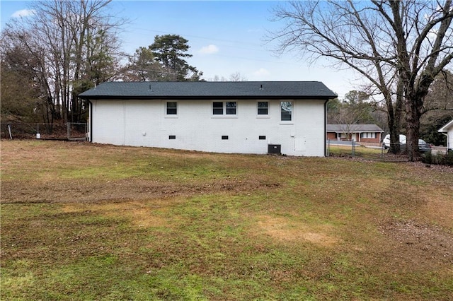 rear view of house featuring a lawn