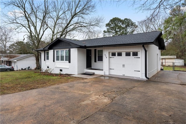 single story home featuring a garage and a front yard