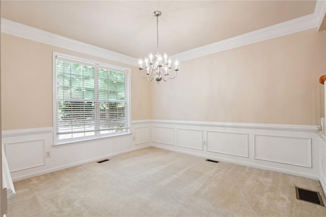 unfurnished room with a notable chandelier, light colored carpet, and ornamental molding