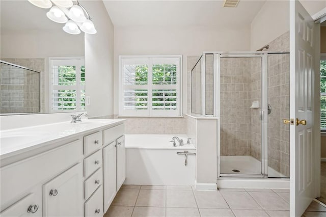 bathroom with tile patterned floors, shower with separate bathtub, and dual bowl vanity