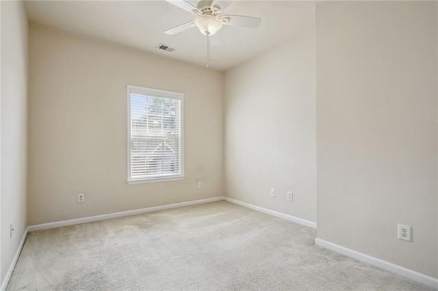 carpeted spare room featuring ceiling fan