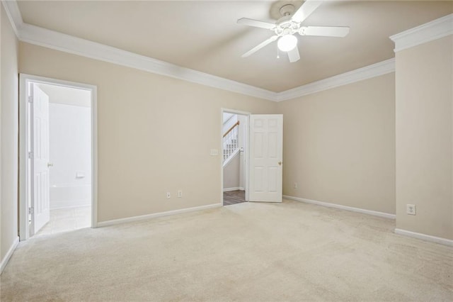 unfurnished room featuring ceiling fan, light carpet, and crown molding