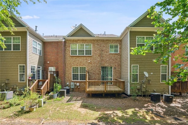 rear view of house featuring a wooden deck and cooling unit