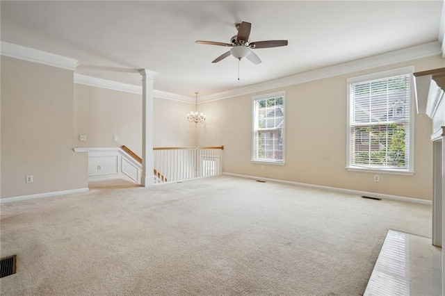 empty room with a wealth of natural light, light carpet, ceiling fan with notable chandelier, and ornamental molding