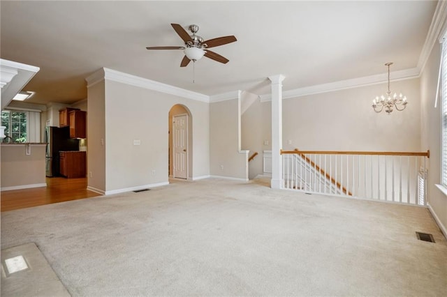 spare room with ceiling fan with notable chandelier, light hardwood / wood-style flooring, and ornamental molding