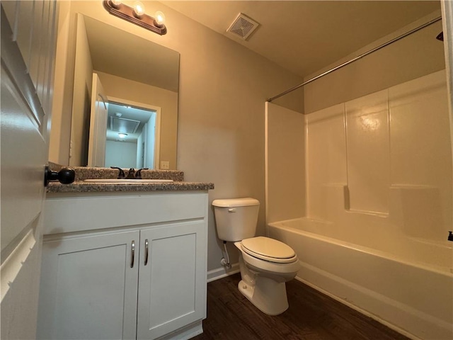 full bath with visible vents, toilet, wood finished floors, bathtub / shower combination, and vanity