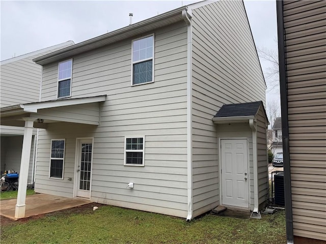 back of property with cooling unit and a patio