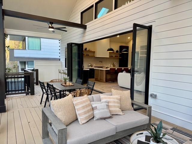 deck featuring outdoor dining area and ceiling fan