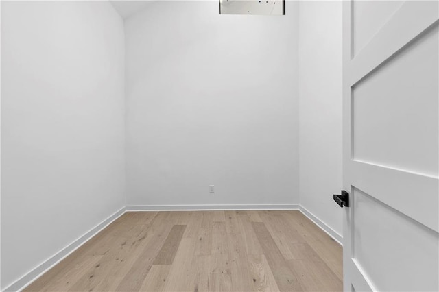 spare room with light wood-type flooring and baseboards