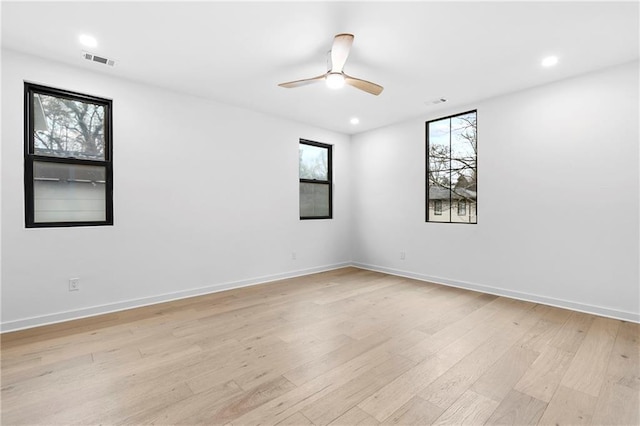 unfurnished room with visible vents, baseboards, light wood-style floors, and ceiling fan