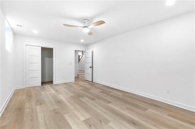 unfurnished bedroom with visible vents, ceiling fan, baseboards, light wood-type flooring, and a closet