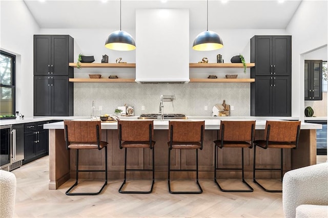 kitchen featuring open shelves, a breakfast bar area, light countertops, and backsplash