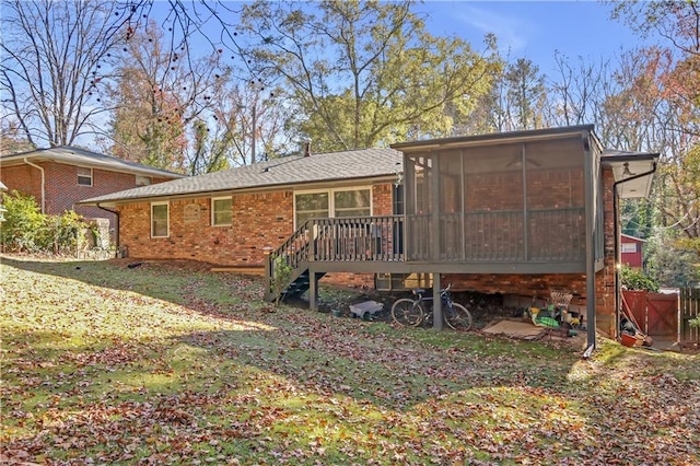 back of house with stairs, brick siding, and a sunroom