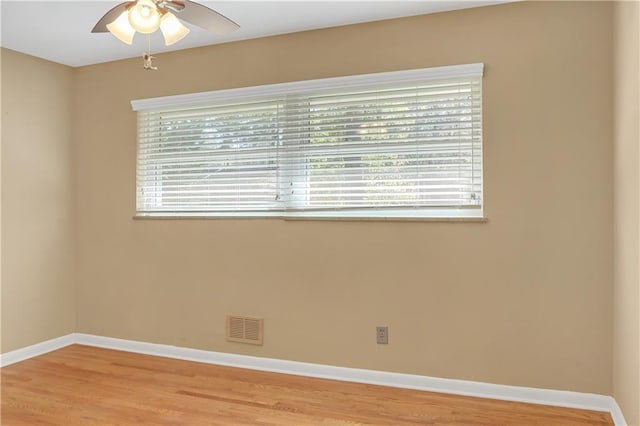 unfurnished room featuring visible vents, plenty of natural light, light wood-style flooring, and baseboards