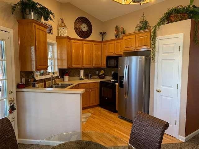 789 N Falling Waters Dr N, Demorest, GA 30535 - kitchen featuring black appliances, a sink, light countertops, a peninsula, and high vaulted ceiling