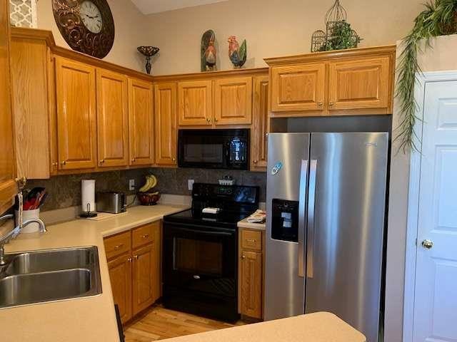789 N Falling Waters Dr N, Demorest, GA 30535 - kitchen with black appliances, a sink, light countertops, and tasteful backsplash