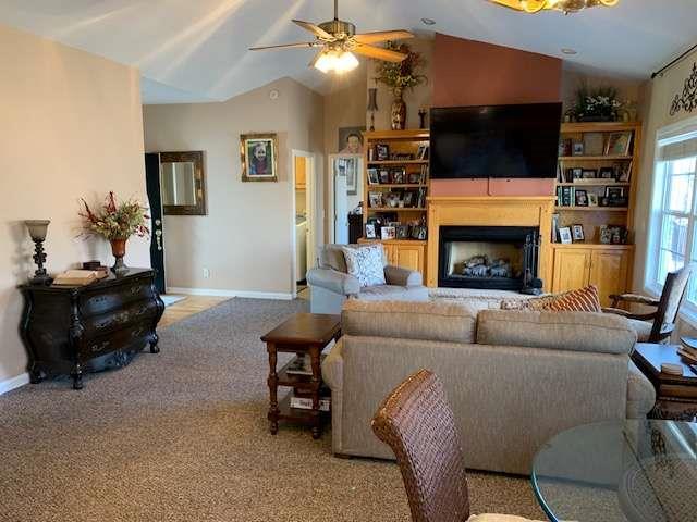 789 N Falling Waters Dr N, Demorest, GA 30535 - carpeted living room featuring vaulted ceiling, a fireplace, ceiling fan, and baseboards