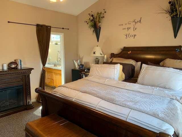 789 N Falling Waters Dr N, Demorest, GA 30535 - bedroom featuring carpet flooring, a glass covered fireplace, and ensuite bathroom
