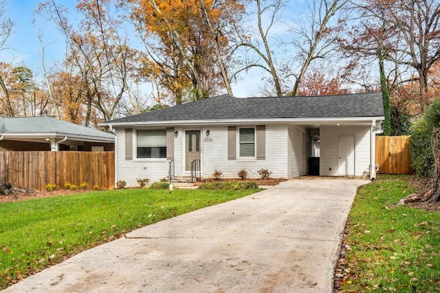 ranch-style home featuring driveway, roof with shingles, fence, a front lawn, and brick siding