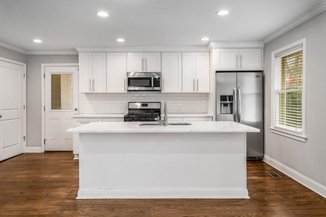 kitchen with ornamental molding, stainless steel appliances, and decorative backsplash