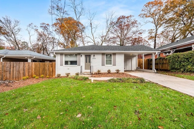 view of front of home featuring driveway, an attached carport, fence, a front yard, and brick siding