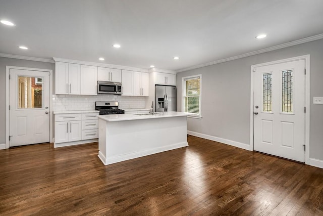 kitchen featuring dark wood-style floors, appliances with stainless steel finishes, ornamental molding, and tasteful backsplash